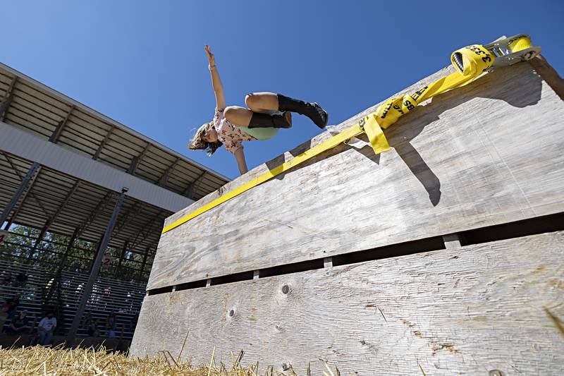 Evelyn Geerts, 8, of Milledgeville soars over a wall Saturday, August 12, 2023 while competing in the Ninja Farmer course at the Carroll County Fair. Kids ran, jumped, climbed and crawled through a series of obstacles while being timed.