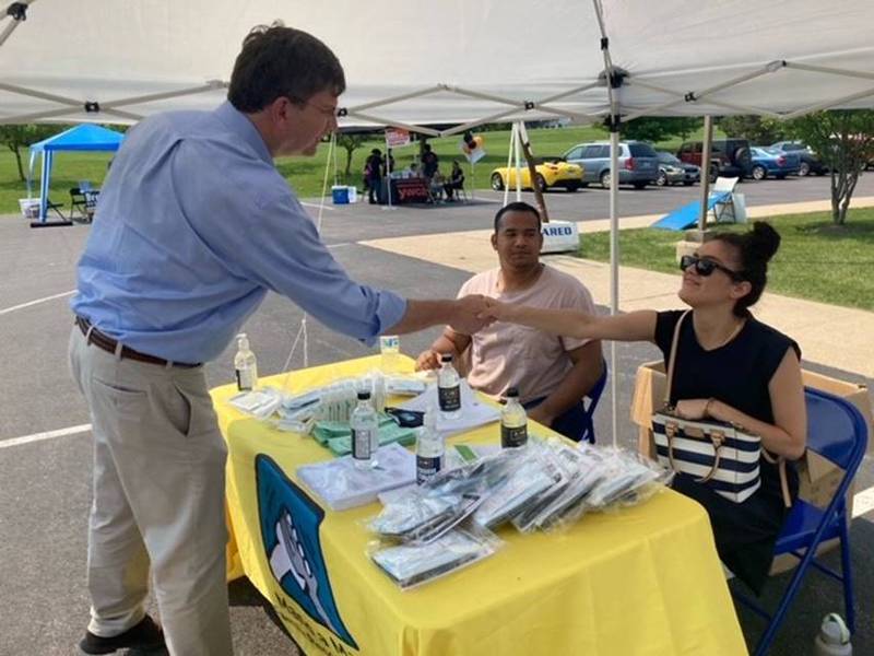 U.S. Rep. Brad Schneider visits with Mano a Mano, a family resource organization serving Lake County that aims to empower immigrants within their communities, at the YWCA Metropolitan Chicago Community Resource Fair in Gurnee.