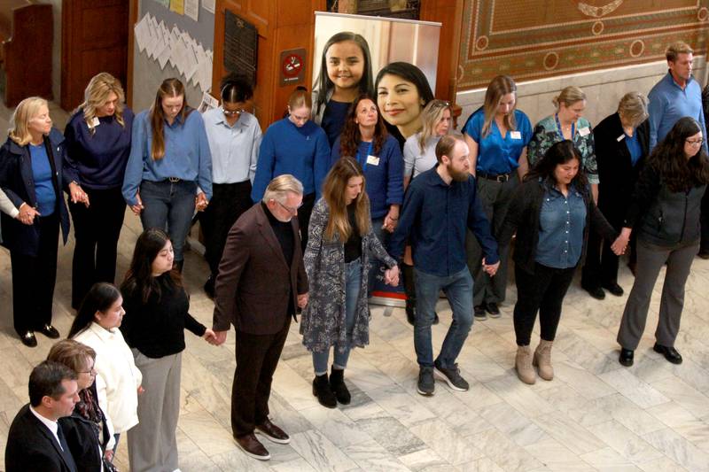 Participants join hands during the annual Hands Around the Courthouse in honor of National Child Abuse Prevention Month on Thursday, April 10, 2025 at the Kane County Courthouse in Geneva.