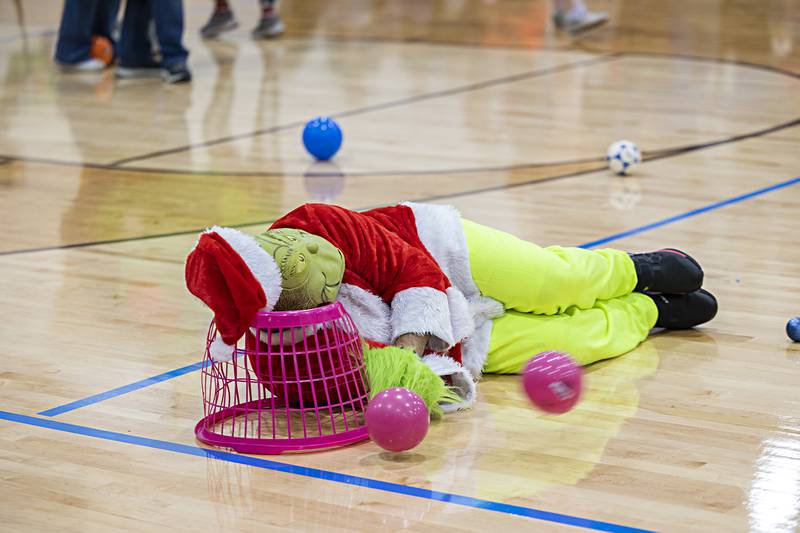 Grinch baits the kids with a fake nap during Rock Falls’ Hometown Holiday’s Grinch dodgeball Saturday, Nov. 18, 2023. The king of anti-Christmas went toe-to-toe with groups of kids in the contest.