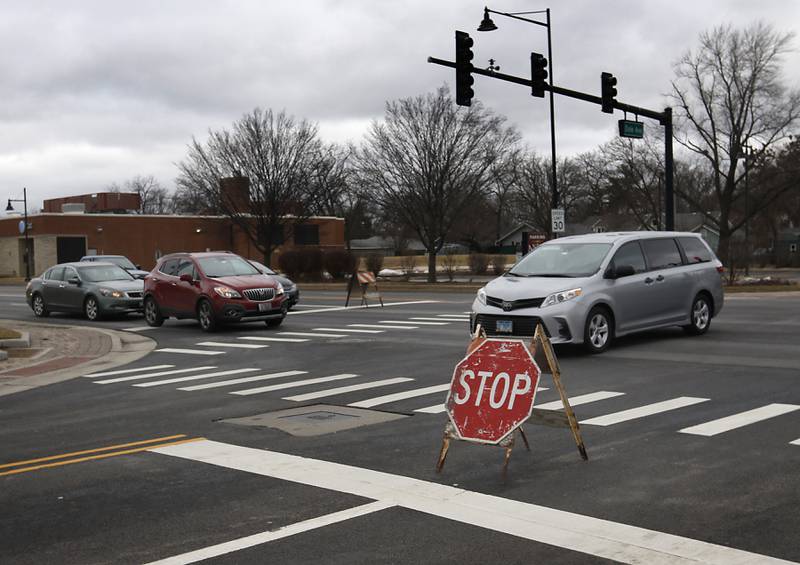 Traffic navigates a four-way stop at the intersection of Dole Avenue and Route 14 where the traffic lights were not operating on Thursday, Feb. 23, 2023, as county residents recover from a winter storm that knocked down trees and created power outages throughout McHenry County.