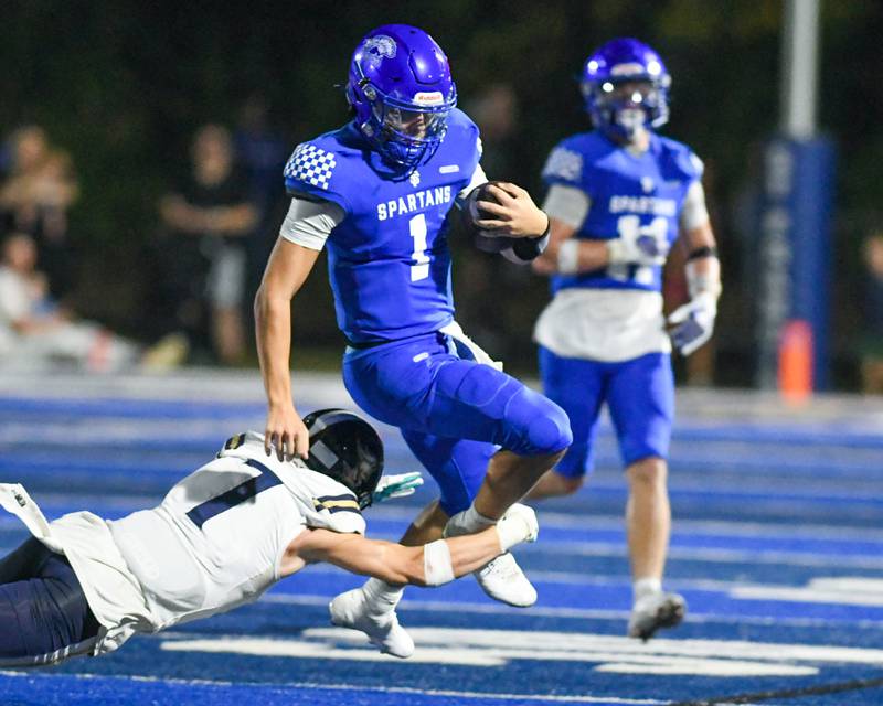St. Francis's ball carrier Brock Phillip (1) runs the ball before being brought down by IC Catholic Prep's Anthony Carroccio (7) during the game on Friday Oct. 3, 2025, held at St. Francis High School.