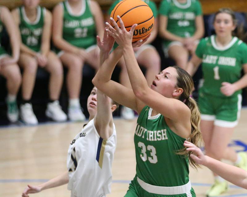 Seneca's Audry McNabb eyes the hoop as Marquette's Kaitlyn Davis defends on Thursday, Dec. 5, 2024 in Bader Gym at Marquette High School.