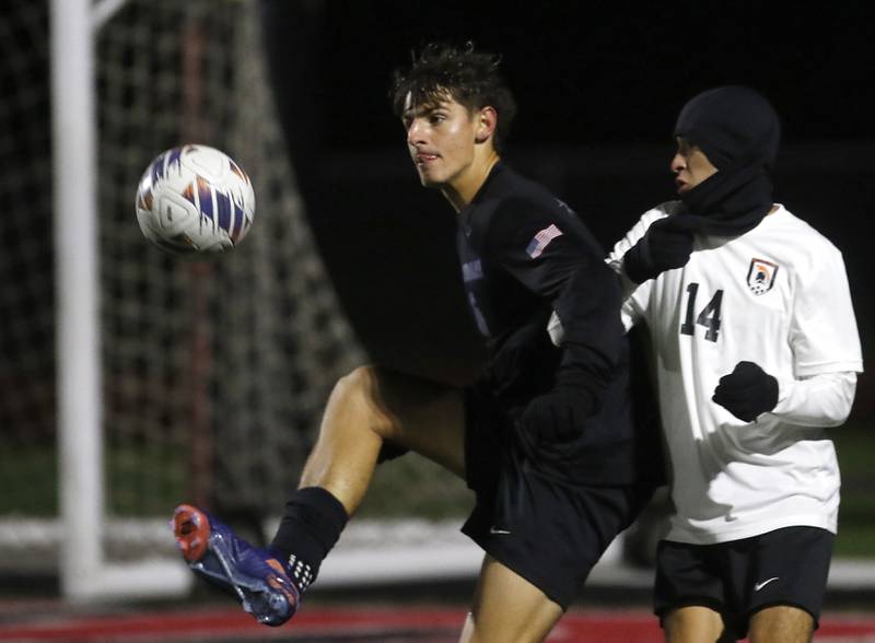 St. Charles North's Dino Valenti controls the ball in front of McHenry's Kyren Rivard during an IHSA Class 3A Huntley Regional boys soccer semifinal match on Tuesday, Oct. 21, 2025, at Huntley High School.