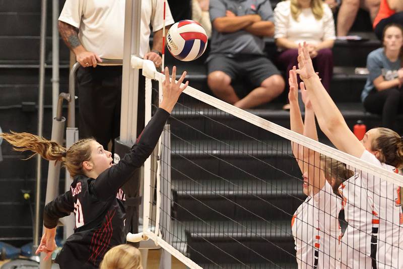 Indian Creek's Audrey Witte tries to tip the ball over two DeKalb defenders during their match Tuesday, Sept. 6, 2022, at Indian Creek High School in Shabbona.