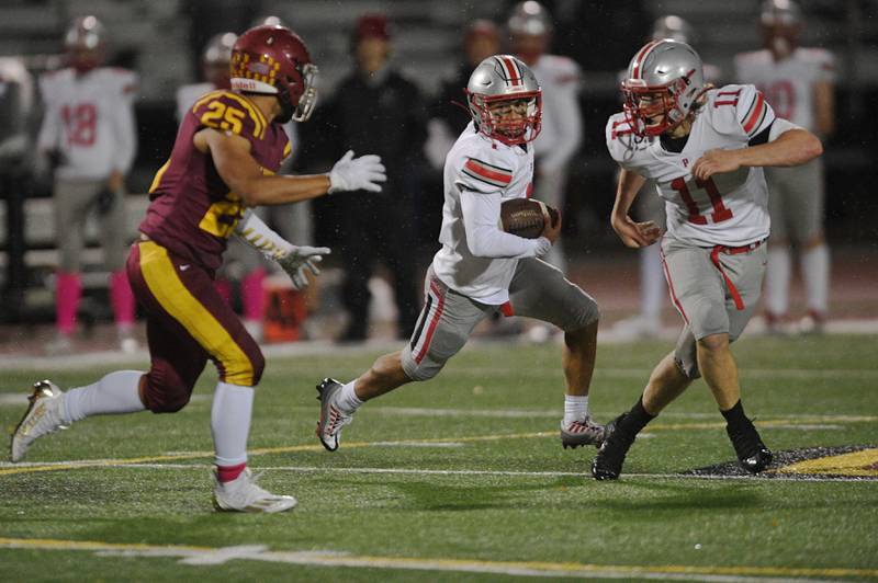 Palatine’s Rocco Paddack runs for a touchdown with blocking her from Trey Widlowski in a football game in Schaumburg on Friday, October 14, 2022.