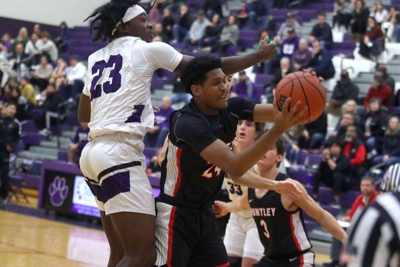 Huntley’s Noah Only, right, battles past Hampshire’s Aman Adeshina in boys basketball at Hampshire on Friday.