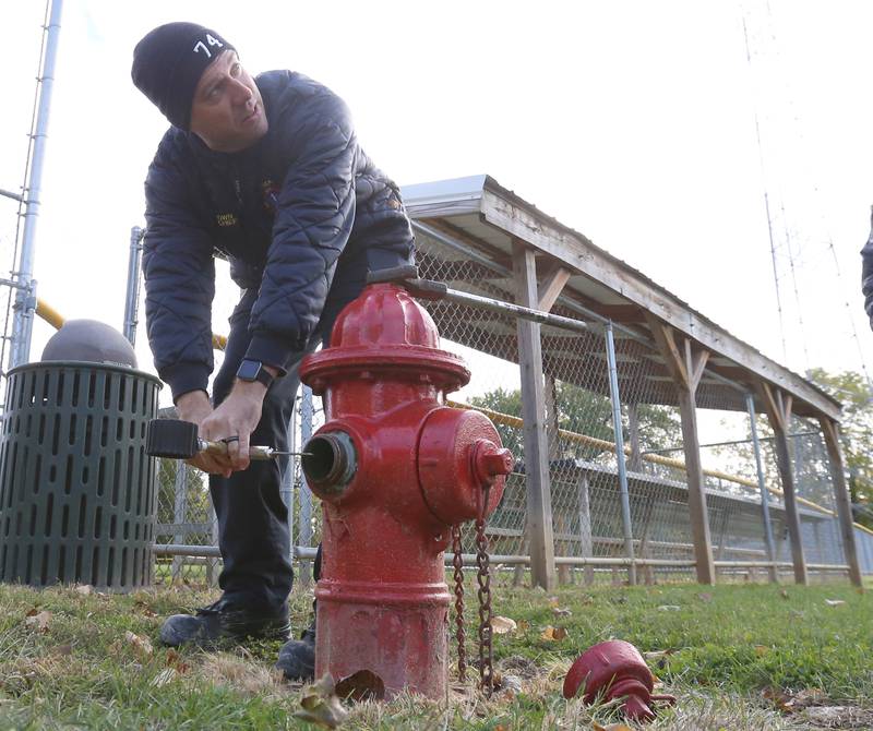 Utica Fire Chief Ben Brown pitot gauge to measure the output of the water flow on a hydrant with on Monday Oct. 17, 2022 at Neighbors Park in Utica. Utica Fire Department is applying for a federal grant to upgrade their hydrants and prevent another Grand Bear-like fire.