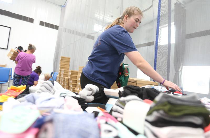 Nikki Lagow volunteer at the Second Story Teen Center sorts through over a 1,000 pair of socks during the Shoes and Socks Giveaway on Saturday, Aug. 2, 2025 at the Second Story Teen Center in Princeton.