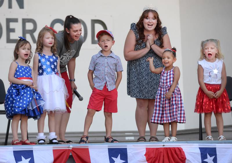 Let Freedom Ring Little Miss and Mister Firecracker, Hunter Taylor, 4, and Zuraya Ritt, 4, (center) shout out Let Freedom Ring with their fellow contestants, Lucy Skoumal, 4, Esther Skoumal, 6, and Aniyah Eggleston, 4, after the contest on Wednesday, July 2, 2025 in Mt. Morris. Also pictured are contest officials Heidi Nicholson and Abi Fletcher, the 2024 Let Freedom Ring Queen.