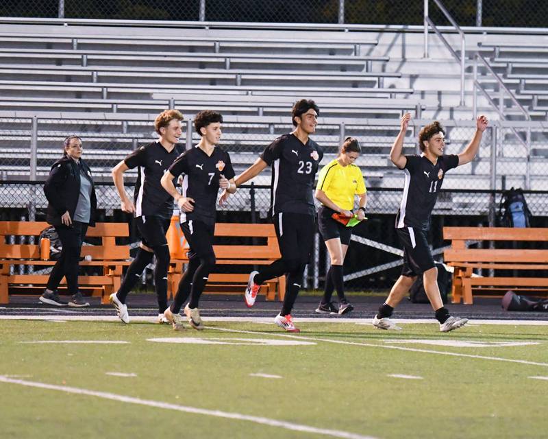 Wheaton Warrenville South’s boys soccer bench is all smiles and runs onto the field after taking the victory over Wheaton North 2-0 on Thursday Sept. 11, 2025, held at Wheaton Warrenville South.