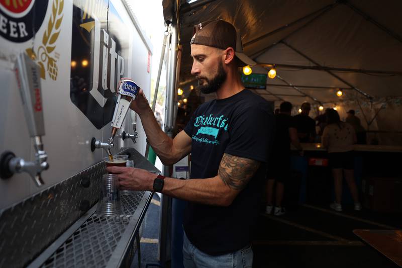 Matt Nickel pours a beer in the Beer Tent at the Saint Dennis and Joseph Catholic Academy Annual Oktoberfest on Saturday, Oct. 5, 2024 in Lockport.
