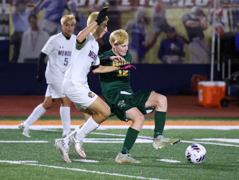 Coal City's Carter Hollis tries to hold off Mendota's Johan Cortez Thursday, Nov. 6, 2025, during their Class 1A state semifinal game at Hoffman Estates High School.