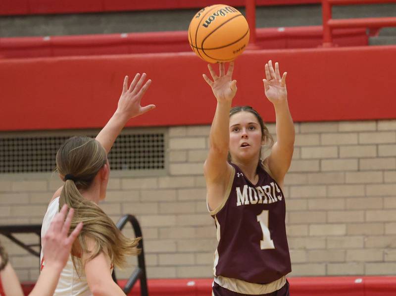 Morris's Cami Pfeifer takes a jump shot over Ottawa's Ashlynn Ganiere on Tuesday, Dec. 9, 2025 in Kingman Gymnasium at Ottawa High School.
