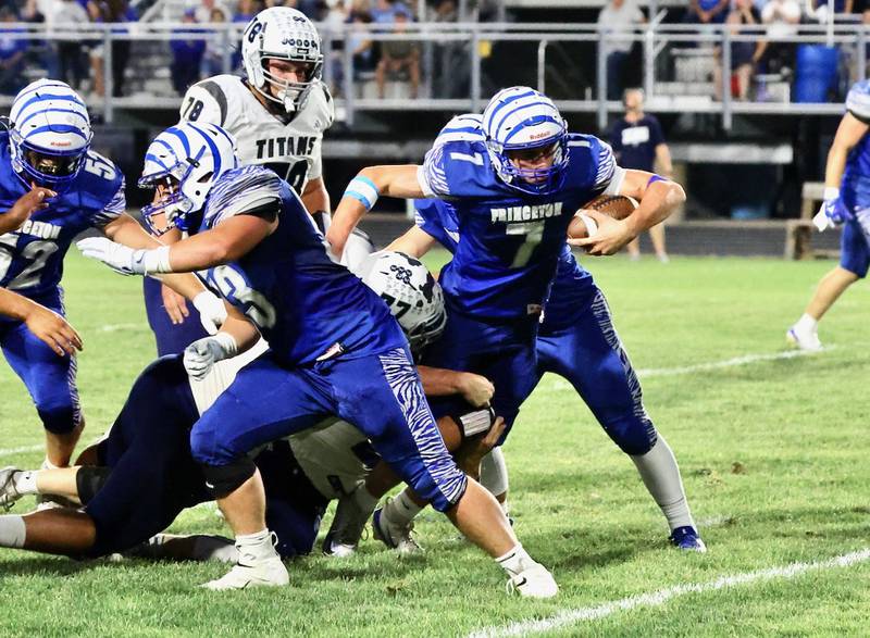 Princeton senior quarterback Gavin Lanham fights for yards in Friday's homecoming game at Bryant Field against Monmouth-Roseville. The Titans won 36-6.
