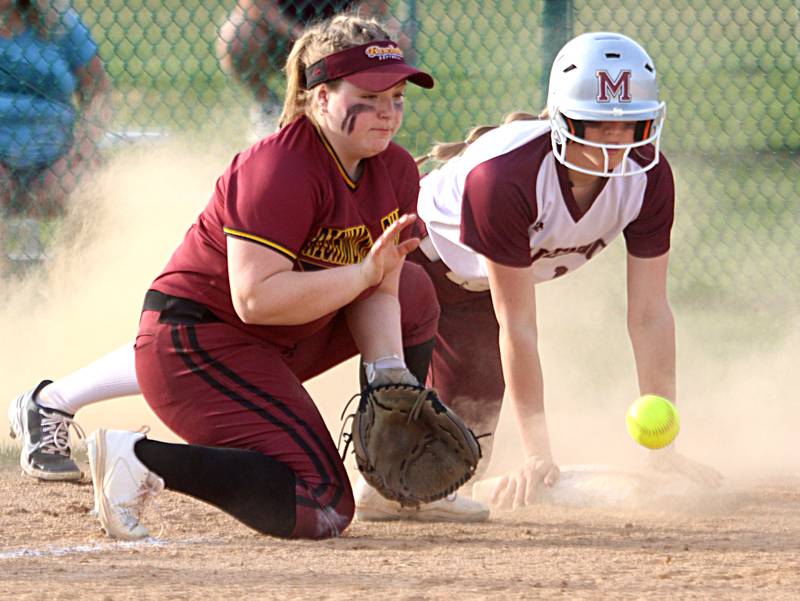 Marengo’s Kylee Jensen, right, slides safely into third base as Richmond-Burton’s Lyndsay Regnier awaits the throw in varsity softball at Marengo Tuesday.