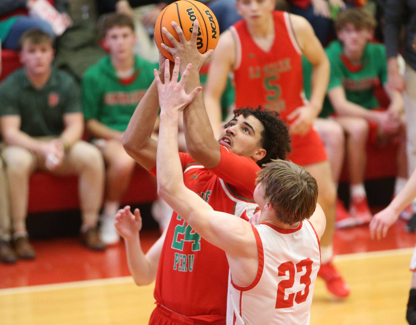 L-P's Marion Persich drives to the hoop as Ottawa's Owen Sanders defends on Friday, Jan. 10, 2024 in Kingman Gym at Ottawa High School.