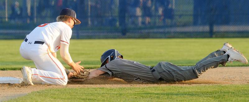 Oswego's Will Pavlick applies the tag out to Oswego East runner Dylan Kubek at 2nd base during a varsity boys baseball game on Thursday, May12, 2022 at Oswego High School.