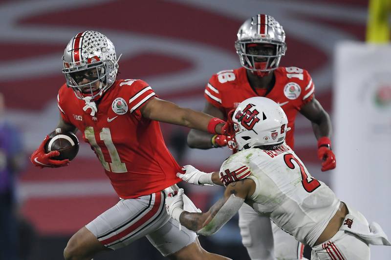 Ohio State wide receiver Jaxon Smith-Njigba runs past Utah cornerback Kenzel Lawle during the 2022 Rose Bowl game in Pasadena, Calif.