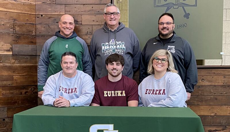 St. Bede senior Ethan Sramek signs to play football Monday for Eureka College. He was joined at his signing by his parents Jerry and Lorna; (back row) St. Bede coaches Bill Booker, Jim Eustice and Mike Bima.