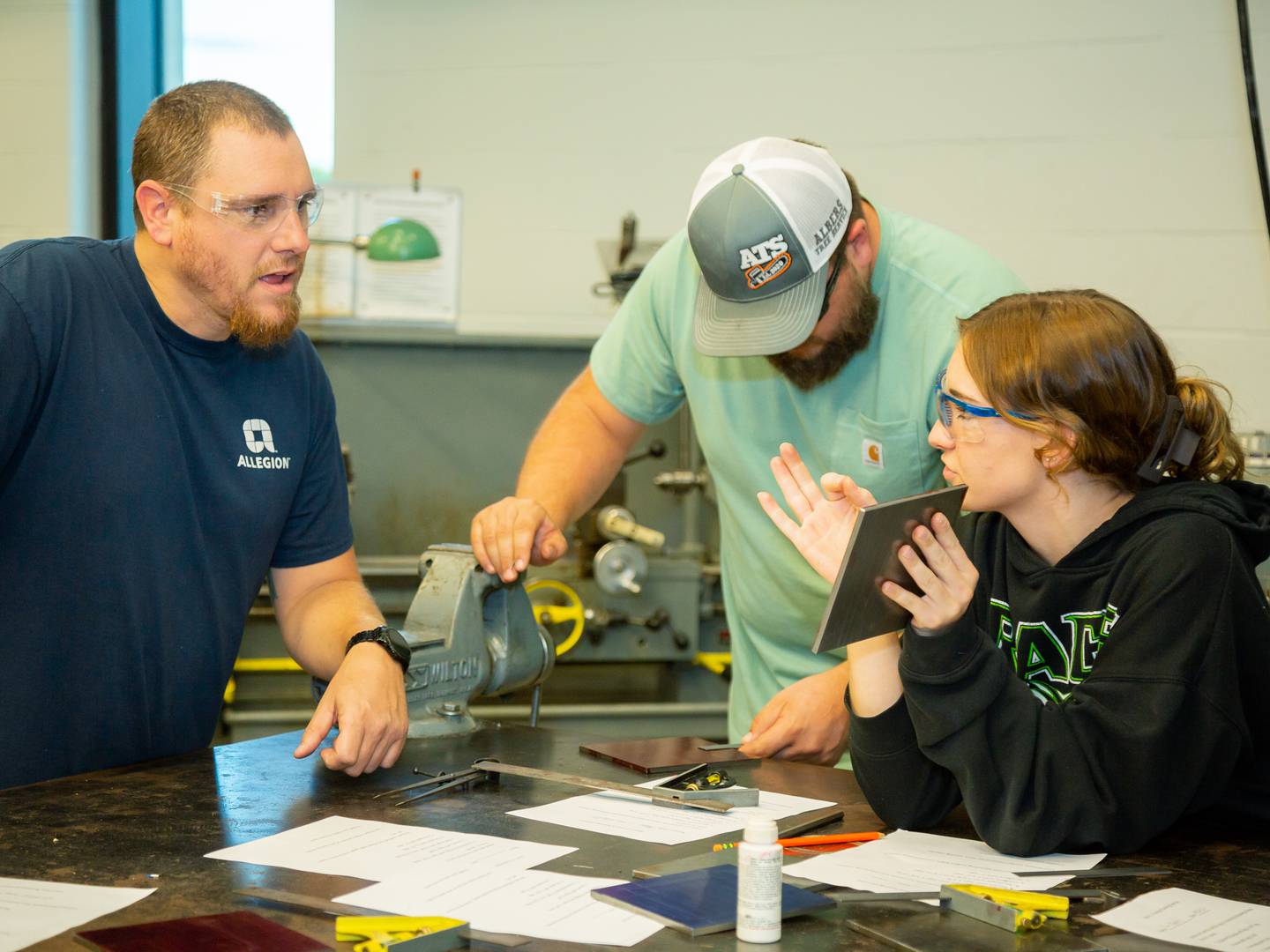 Computer Numerical Control instructor Scott Fox (left) discusses basic part layout with a pair of students this fall.