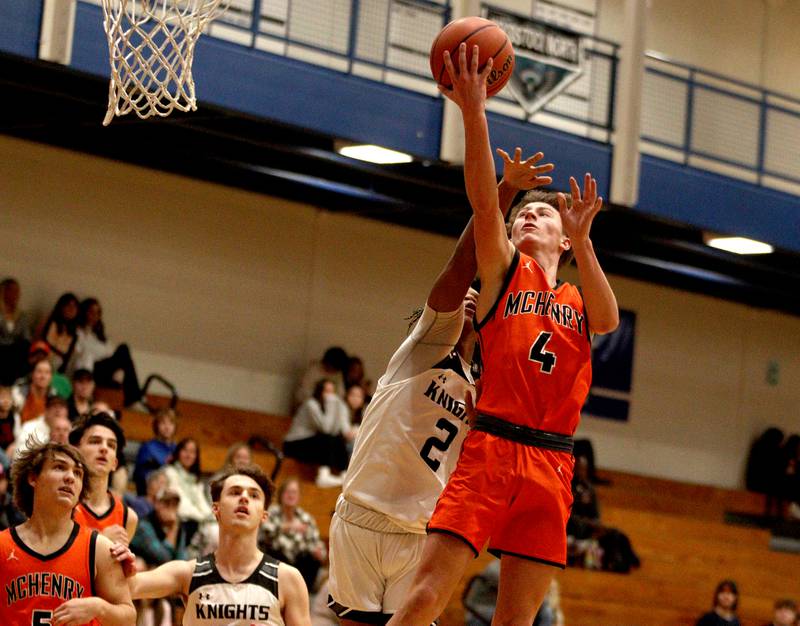 McHenry’s Dylan Hurckes takes the ball to the hoop against Kaneland in Hoops for Healing basketball tournament championship game action at Woodstock Wednesday.