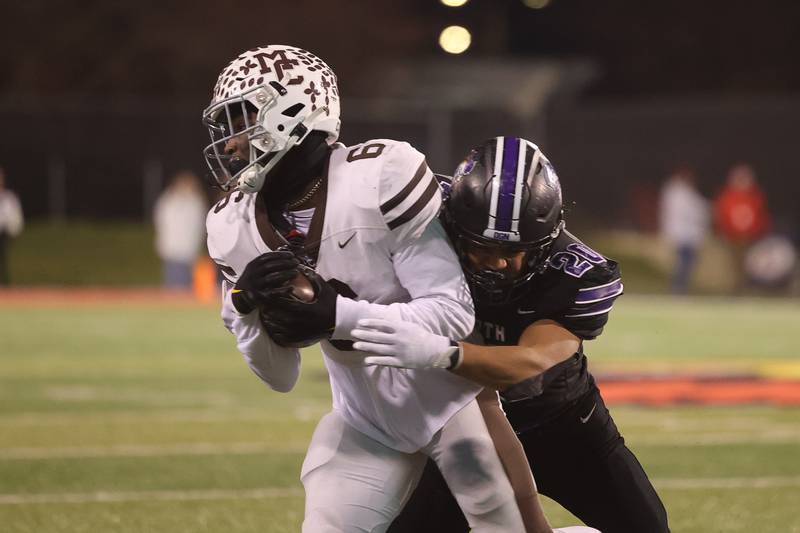 Downers Grove North’s Noah Battle wraps up Mt. Carmel’s Darrion Dupree in the Class 7A championship on Saturday, Nov. 25, 2023 at Hancock Stadium in Normal.
