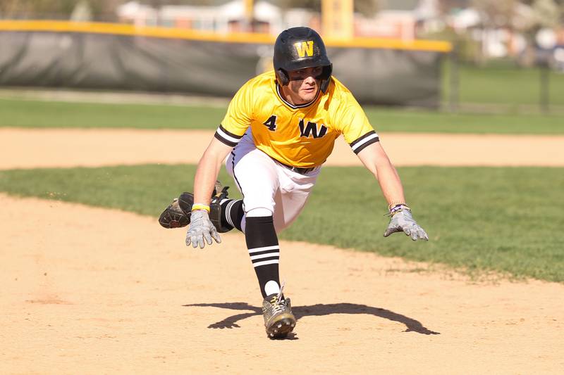 Joliet West’s Ryan Sobun dives into third on a two run triple against Joliet Central on Monday, April 15, 2024.