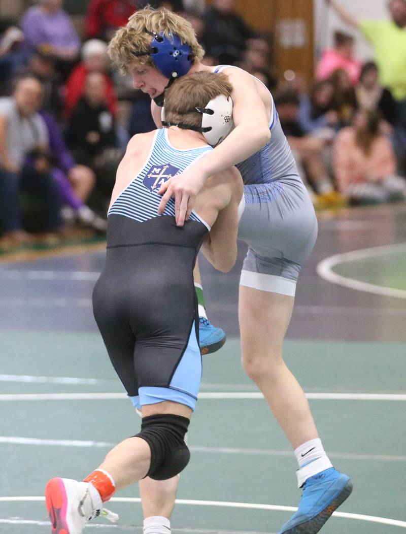 Princeton's Agustus Swanson wrestles Marquette's Koby Clark in the 120 pound weight class during the Class 1A Regional meet on Saturday, Feb. 8, 2025 at St. Bede Academy.