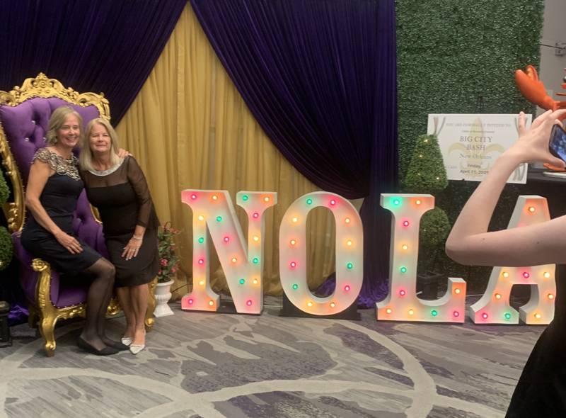 Brenda Schrieber of Elgin and Diana Klein of Algonquin pose at a display for CASA of McHenry County’s next fundraiser, Big City Bash, at CASA's Little Black Dress celebration and fundraiser in Crystal Lake Oct. 10, 2024.