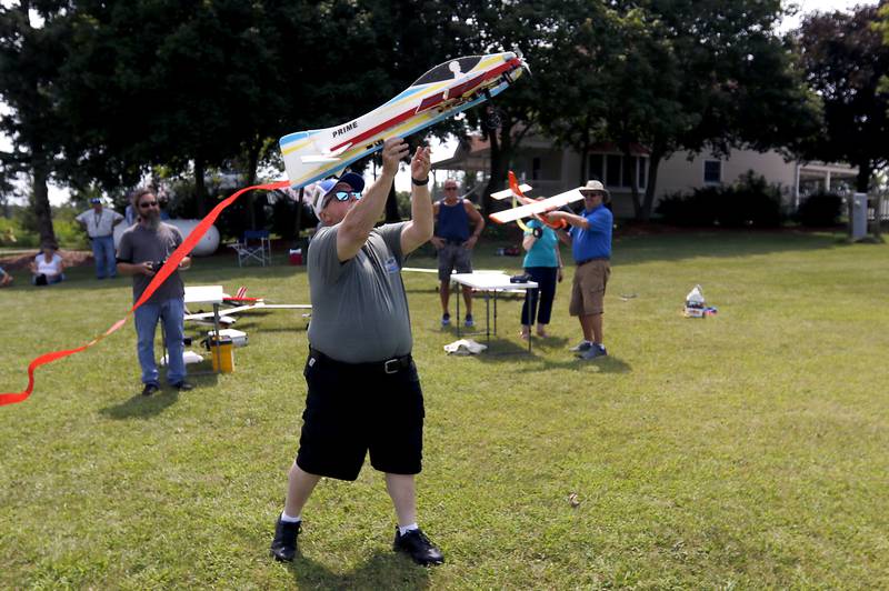 Bill Mielke launches Joe McGinley’s radio-controlled plane on Thursday, Aug. 8, 2024, while flying planes with other members of the Chain-O-Lakes Eagles R/C Club near Hebron.