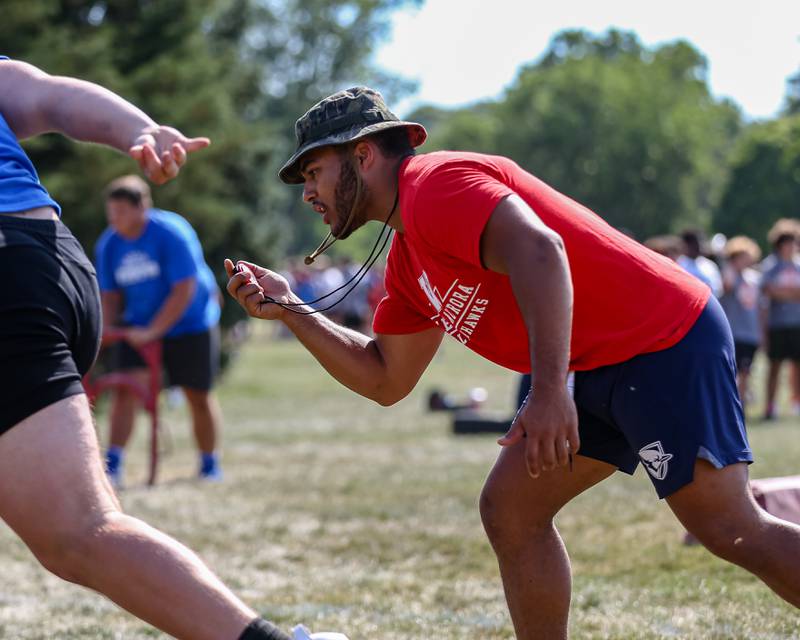 A coach checks his watch at the West Aurora High School Battle of the Big Butts Linemen Challenge.  July 14, 2022.