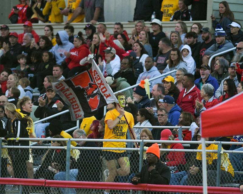 A Yorkville fan runs along the stands carrying a Yorkville flag after scoring a touchdown during the football game against Joliet west on Friday Sept. 5, 2025, held at Yorkville High School.