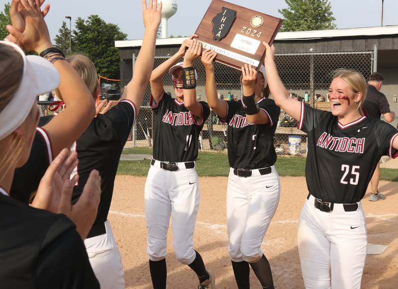 The Antioch captains bring the super sectional plaque back to their team after their Class 3A supersectional win Monday, June 3, 2024, over Sycamore at Kaneland High School in Maple Park.