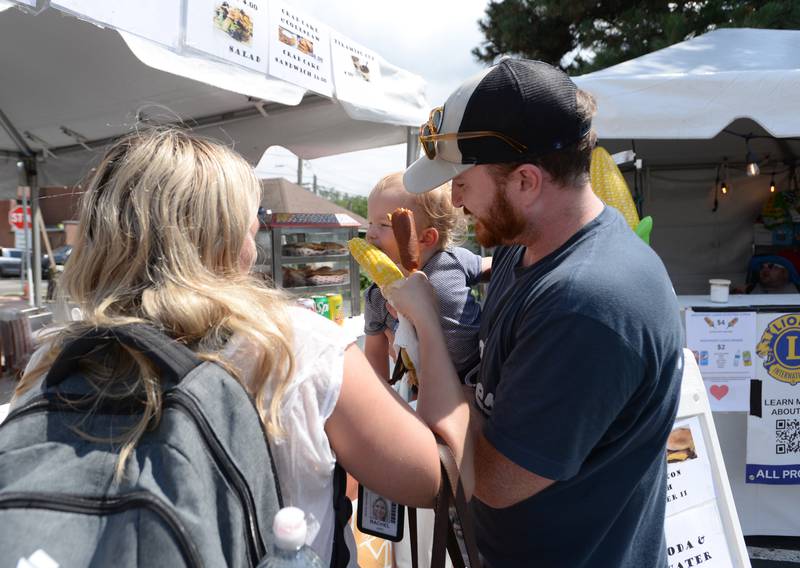 Rachael Jarz of Westmont and Luke Keller help feed Miles Keller during the annual Taste of Westmont Saturday July 12, 2025.