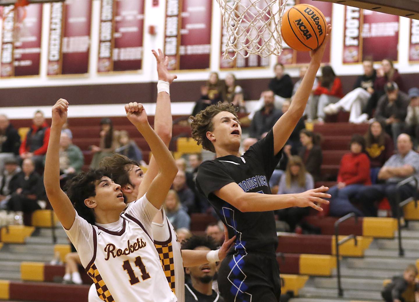 Woodstock's Maxwell Beard drives to the basket in front of Richmond-Burton's Ben Roberts during a Kishwaukee River Conference basketball game on Wednesday, Feb. 5, 2025, at Richmond-Burton High School.