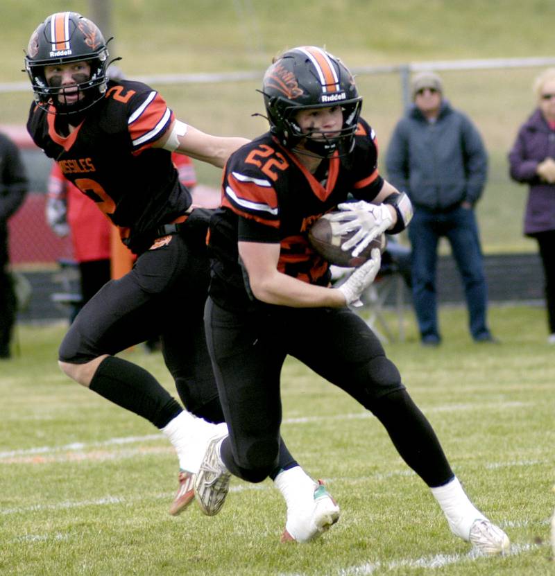 Milledgeville's Jayden Promenschenkel takes a handoff from Kyson Francis. The Milledgeville Missiles defeated the South Beloit SoBos 22-6 in Round 2 of the I8FB playoffs. The game took place at Milledgeville on Saturday, November 8th, 2025