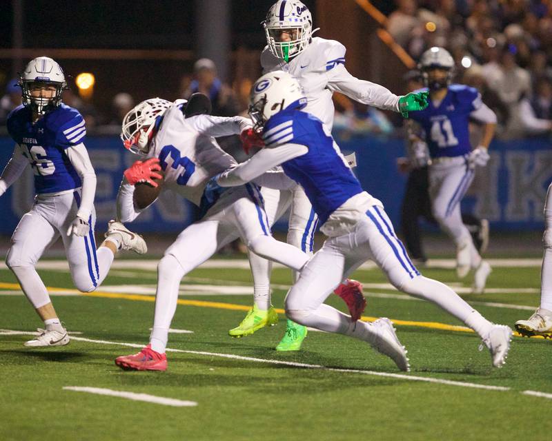 Burlington Central's Rocco Boss makes the running catch as Geneva's Dane Turner goes for the tackle at the Class 6A second-round playoff game on Saturday Nov.9,2024 in Geneva.