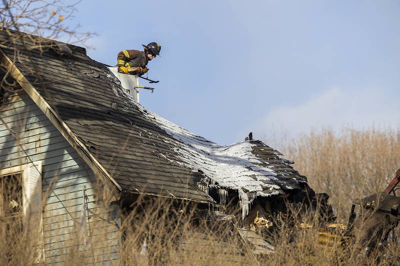 Firefighters continue their search Monday, Jan. 20, 2025, of a possible victim of a house fire in rural Sterling.