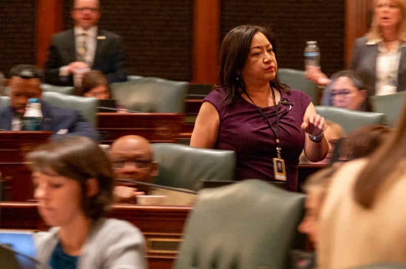 Rep. Theresa Mah, D-Chicago, rushes across the House floor shortly after her bill failed