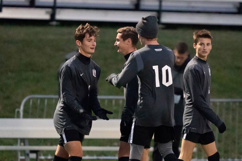 Wheaton Academy's Joshua Mariotti (17) is greeted by his team mates after scoring a goal against Johnsburg during a Wheaton Academy 1A sectional semifinal match at Wheaton Academy on Tuesday, Oct 18, 2022.