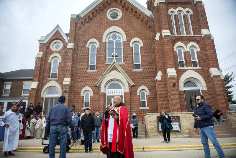 Father Carlos Monsalve begins the stations of the cross Friday, April 15, 2022 outside of St. Mary’s Church in Sterling. The stations recognizes the last moments of Jesus’ life as he made his way to the crucifixion.