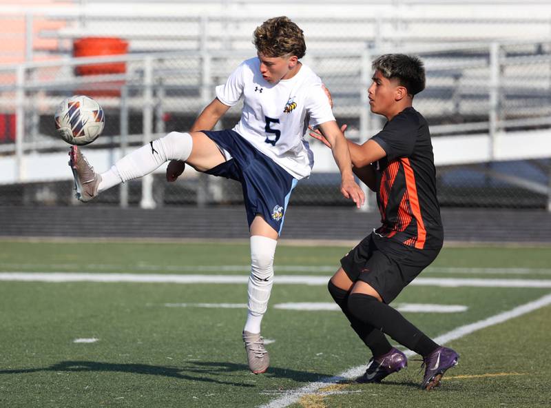 Guilford's Daniel Martinez kicks the ball away from DeKalb's Jonathan Contreras during their game Thursday, Sept. 18, 2025, at Dekalb High School.