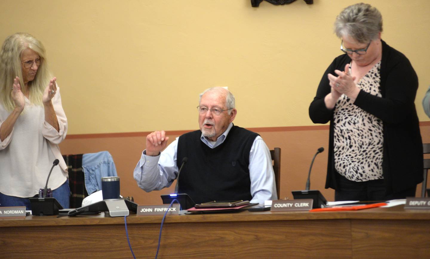 Retiring Ogle County Board Chairman John Finfrock (center) delivers his closing comments as  Vice Chairman Patricia Nordman (left) and County Clerk & Recorder Laura Cook stand with the rest of the Ogle County Board at the end of  Ogle County Board meeting on Tuesday, Nov. 19, 2024. Finfrock has been a board member since 2010, serving as chairman since 2019.