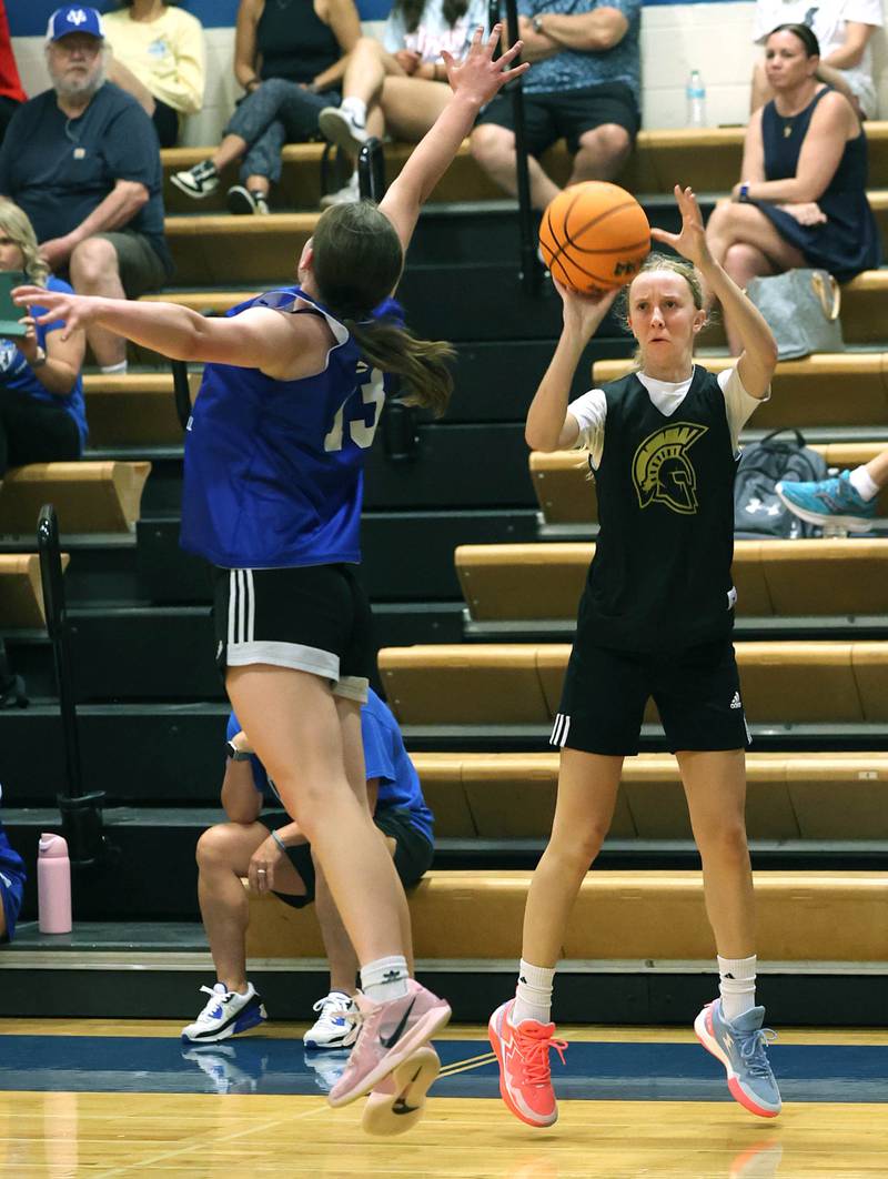 Sycamore’s Sadie Lang puts up a three pointer as Geneva’s Linnea Popp plays defense Thursday, June 12, 2025, in the Geneva High School Varsity Summer League.
