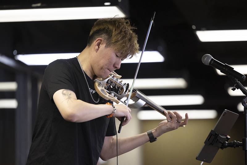 Electric violinist Alex Ahn entertains a crowd at Sauk Valley Community College Monday, March 20, 2023.