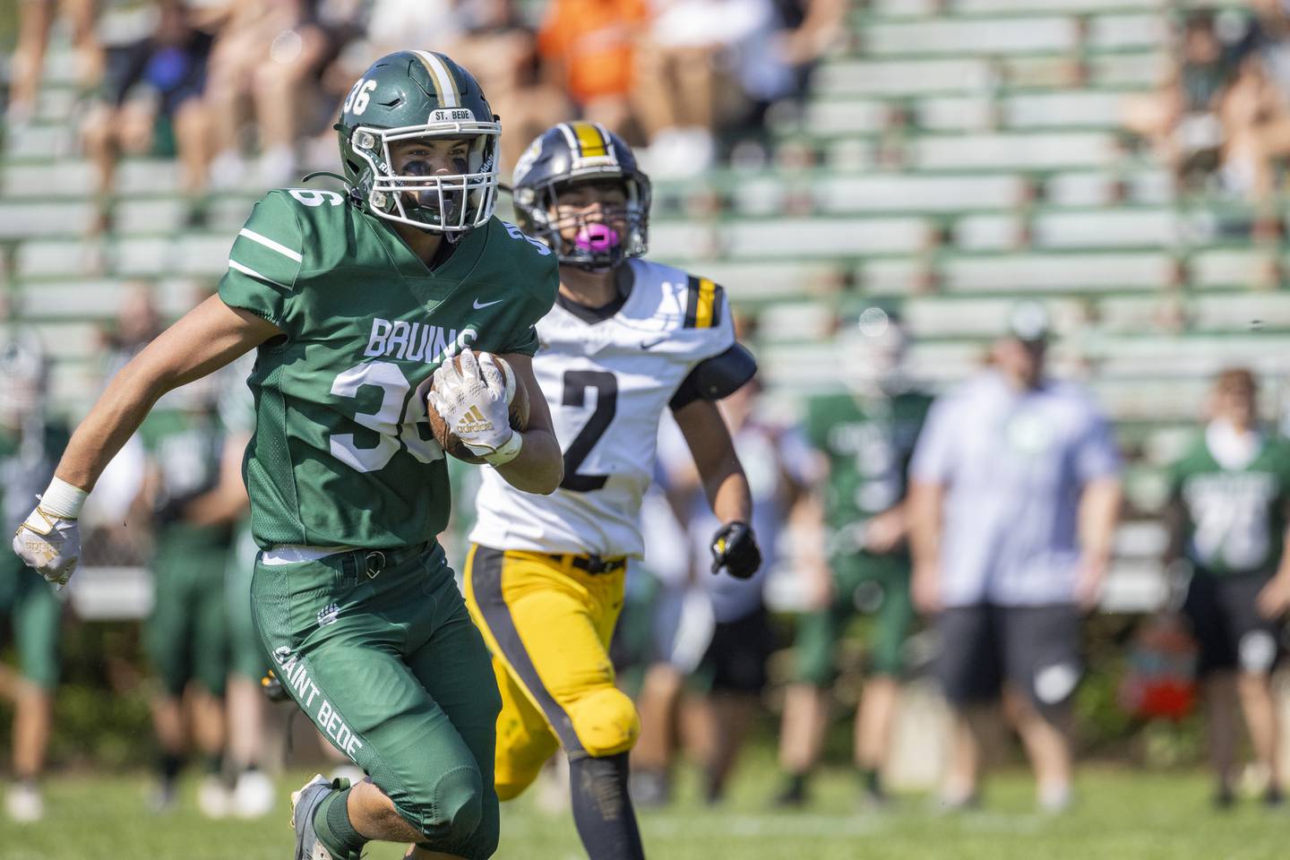 Landon Marquez of St. Bede outruns Jacob Solis of Elmwood Park during the homecoming game on September 30, 2023.