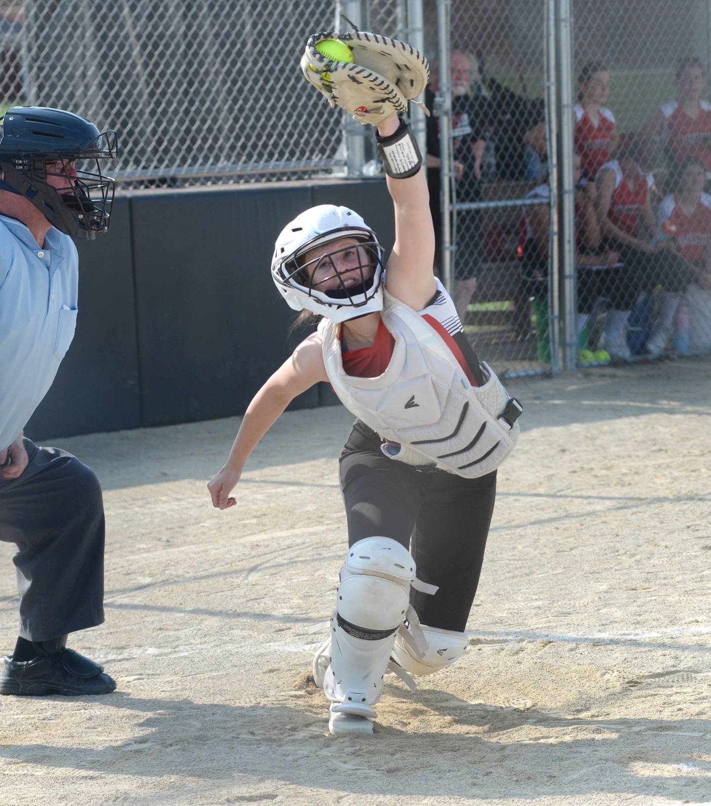 Forreston catcher Hailey Greenfield catches a high pitch during Tuesday's game against Orangeville at the 1A Forreston Sectional. The Cardinals lost the game 9-1.