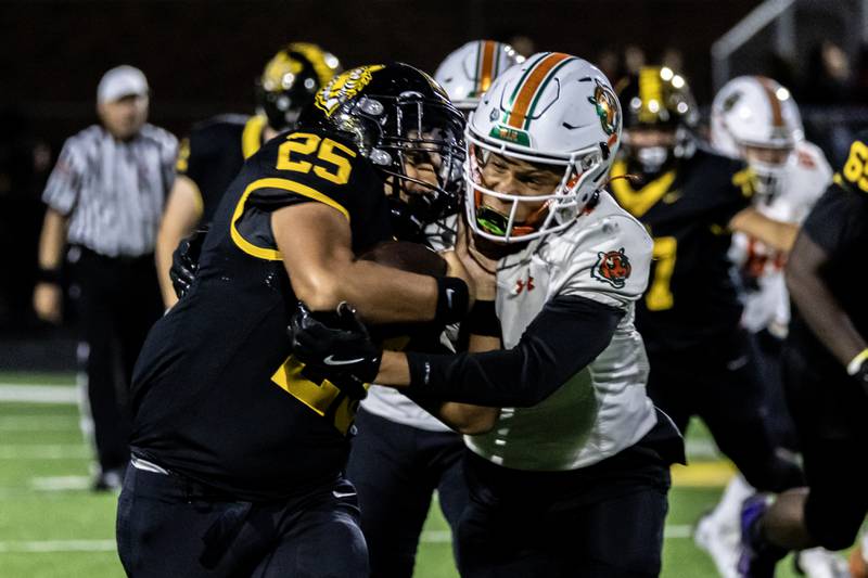 Joliet West's Andrew Santiago gets pushed out of bounds by Plainfield East's Dinari Overton during a varsity football game at Joliet West on Oct. 10, 2025.