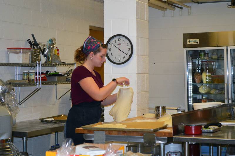 Jen's Artisan Breads employee Sarah Meacham, of Mount Morris, works on preparing dough for a pizza crust on Friday, Feb. 16, 2024.